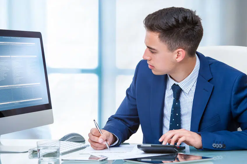 Accountant working on budget at desk.